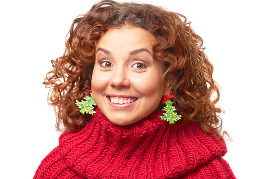 Pretty smiling young woman with christmas tree shape earrings.