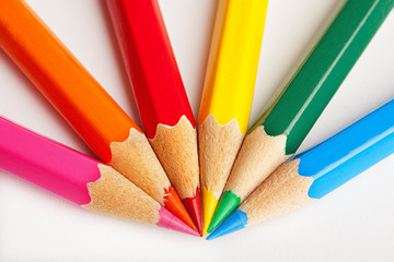 Fototapeta premium colored pencils in the shape of the beam on white background