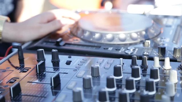 Mani del deejay sul mixer 