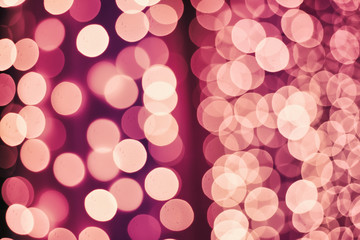 Christmas abstract shiny light bokeh in violet pink colors, vintage retro hipster seasonal holiday background