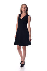 Young pretty long haired blonde woman posing in fashion dress on white background in a studio. Spring summer photo, catalog collection.