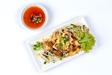 Fried oyster with bean sprouts and shallot as "Hoi Tod" in Thai served with chili sauce.Top View