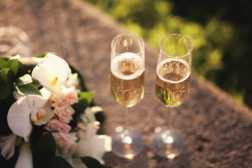 wedding bouquet and two glasses with champagne