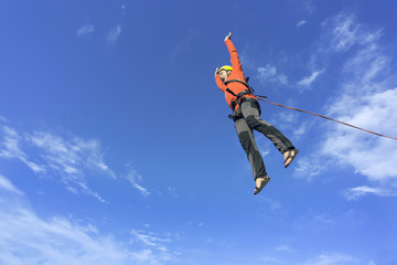 Jump rope from a high rock in the mountains.