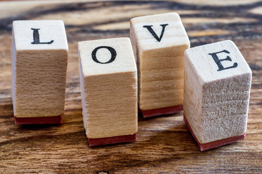 Love Happy Valentines Day Concept. Love Stamp on Vintage Woden Background. Love Word Written in Wood Blocks.