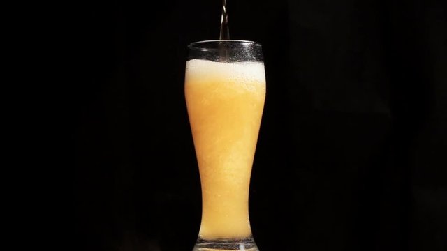 Beer is poured into a glass