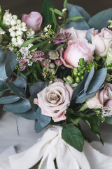 Beautiful wedding bouquet with roses and peonies closeup