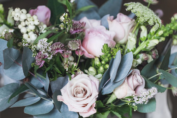 Beautiful wedding bouquet with roses and peonies closeup