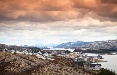 Fototapeta na wymiar Houses under colorful cloudy sky, Norway