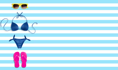Summer beach vacation fashion items isolated on bright stripe background.