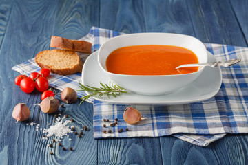 Spicy pumpkin cream soup served in the vintage ceramic bowl with