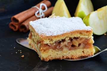 Apple pie square bar with cinnamon and powered sugar.