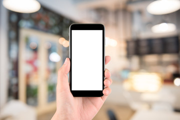 hand holding the phone tablet on blurred in shop or restaurant background;Transactions by smartphone concept