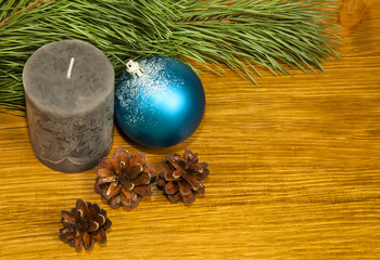 Composition with fir cones and grey candle on wooden background