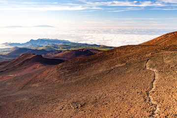Fototapeta na wymiar Inspirational landscape with woman running on mountain trail, Canary Islands view.