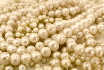 Golden pearl necklace. Shiny jewelry background 