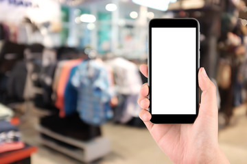 Smart phone with white screen in hand on blurred in shopping mall background,shopping online concept,shopping by smart phone