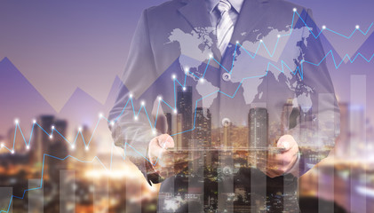 Double exposure of success businessman using digital tablet with city landscape background.Forex graph oon the business city centre. A metaphor of international financial consulting.investment concept