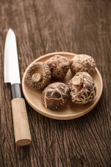 Fototapeta na wymiar dried shiitake mushroom in wood dish for food background
