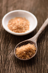 Raw Organic Cane Sugar in a wooden spoon