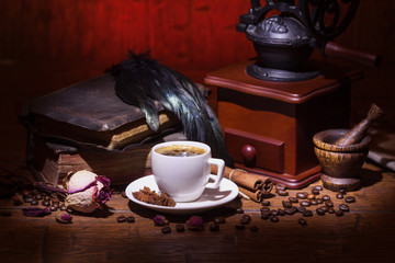 Cup of coffee, dry rose and grinder