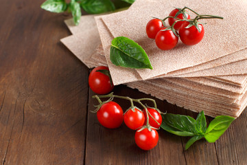 Raw lasagna sheets,basil and cherry tomatoes