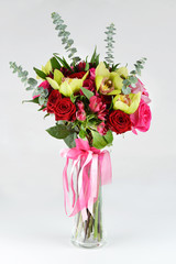 exotic bouquet of flowers in a vase on gray background