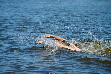 close-up of a man swimming in the water butterfly
