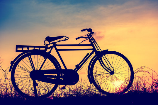 beautiful landscape image with Silhouette  Bicycle at sunset in