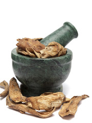 Organic Dried Mango (Mangifera indica) on marble pestle and over white background