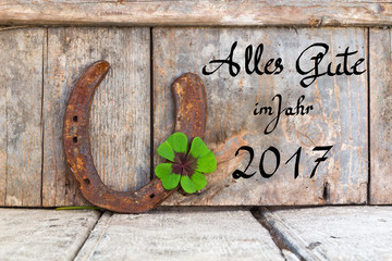 Glücksbringer vor Holzhintergrund, Alles Gute im Jahr 2017