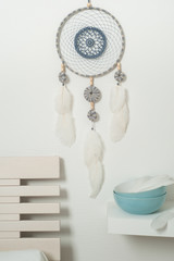 Blue dream catcher with white feathers