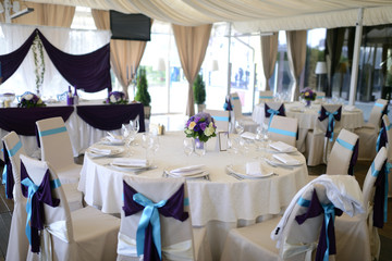 Beautiful wedding restaurant for marriage. White decor for bride and groom. Colorful decoration for celebration. Beauty bridal interior. Bouquet and flowers in hall