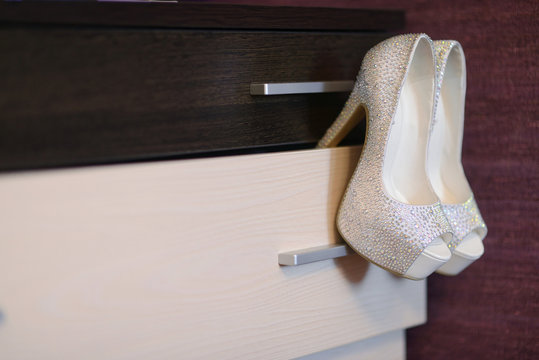 Beautiful colorful wedding shoes for bride indoors. Beauty of bridal heel for marriage. Female couple boots for celebration