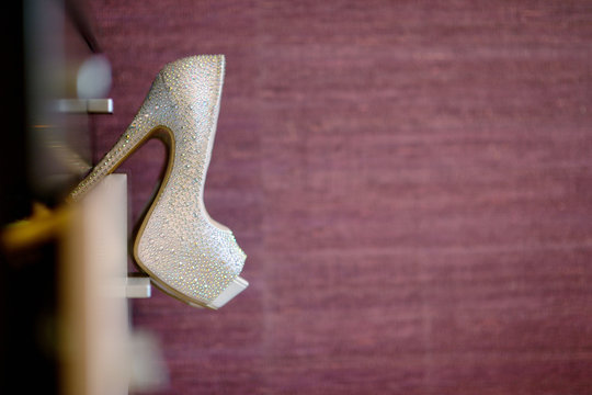 Beautiful colorful wedding shoes for bride indoors. Beauty of bridal heel for marriage. Female couple boots for celebration