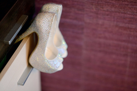 Beautiful colorful wedding shoes for bride indoors. Beauty of bridal heel for marriage. Female couple boots for celebration