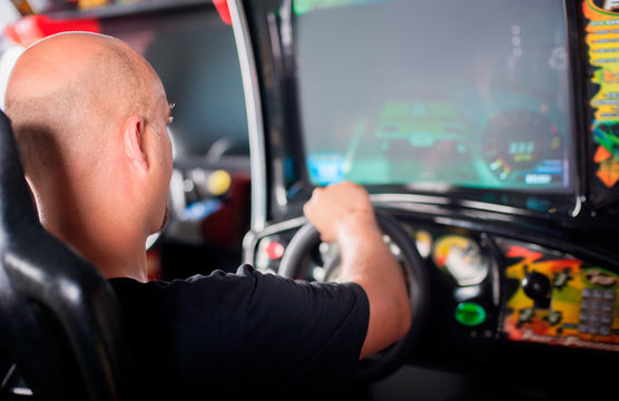Man playing driving wheel video game