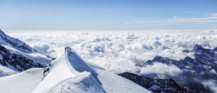 Mountaineers on top of snowy mountain