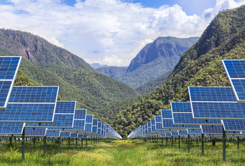 solar photovoltaics panels in solar power station  with mountains  background