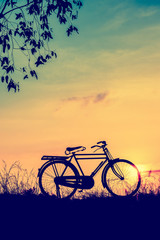 beautiful landscape image with Silhouette  Bicycle at sunset in