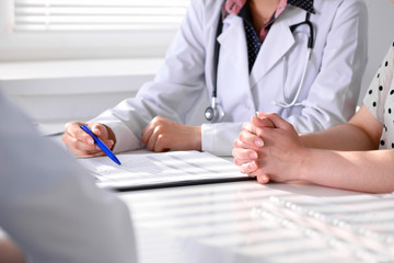 Doctor and patient are discussing something, just hands at the table
