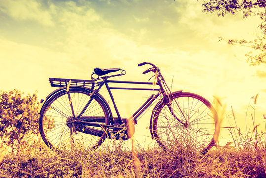 beautiful landscape image with vintage Bicycle at sunset,classic