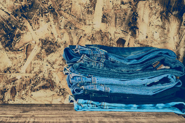 Blue jeans on a brown wooden background.