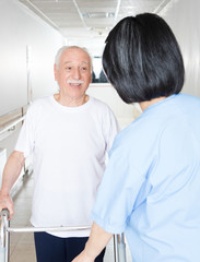 Nurse assisting elder people in a rehab facility gym