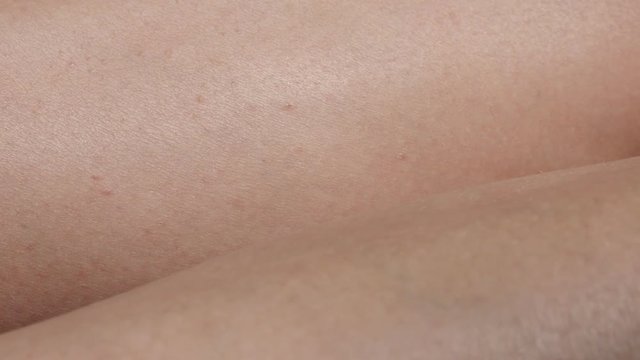 Gentle skin texture of female highly detailed close-up 4K 2160p 30fps UltraHD panning footage - Woman tanned legs after exposing them to sun slow pan 4K 3840X2160 UHD video 