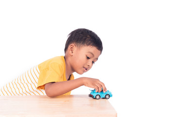 Cute little asian boy child kid preschooler playing with blue ca