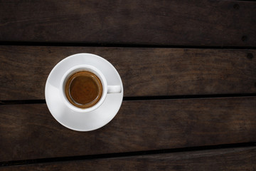Cup of coffee espresso on a wooden background