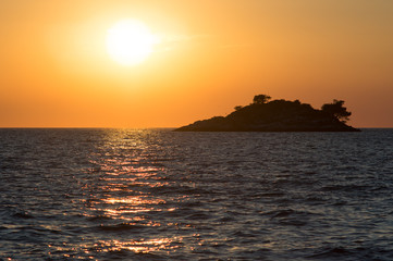 Fototapeta na wymiar golden sunset with an island