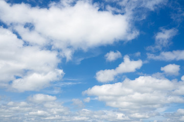 Naklejka na ściany i meble White clouds flying against blue sky.