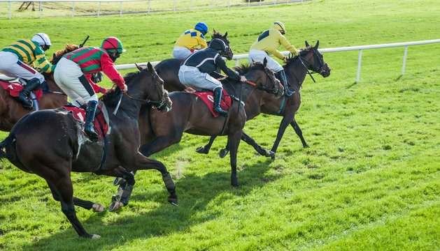 Race horses and jockeys sprinting words the finish line